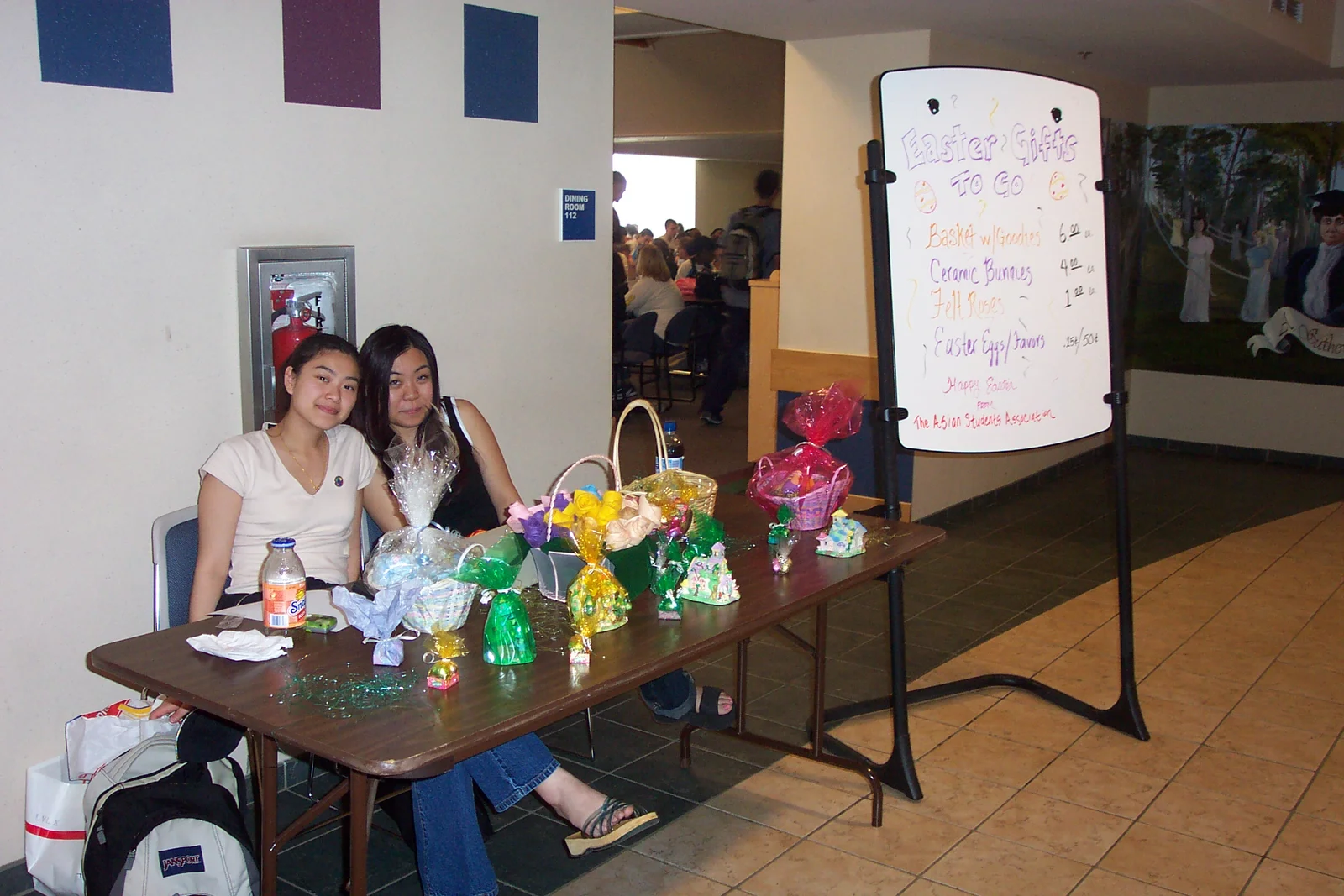 Mai Diep, President of the Asian Student Association, fundraises outside the performance with another club member. 