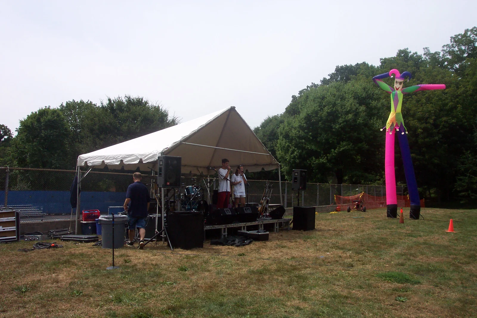 The "fly guy" overshadows the stage where a live band sets up.