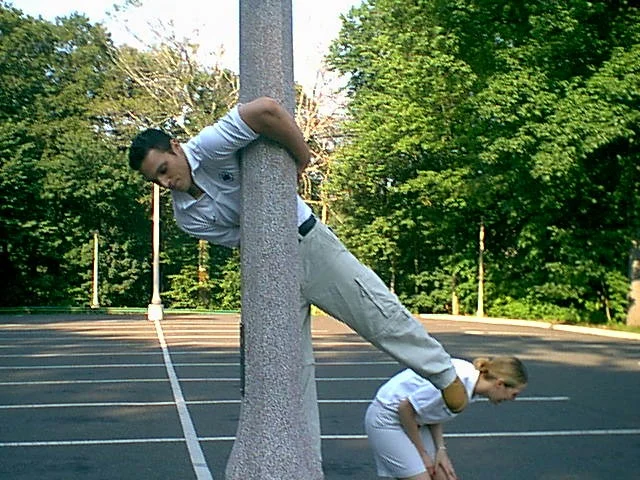 Kristina can't contain her laughter as Soroosh twists himself around a light pole. 
