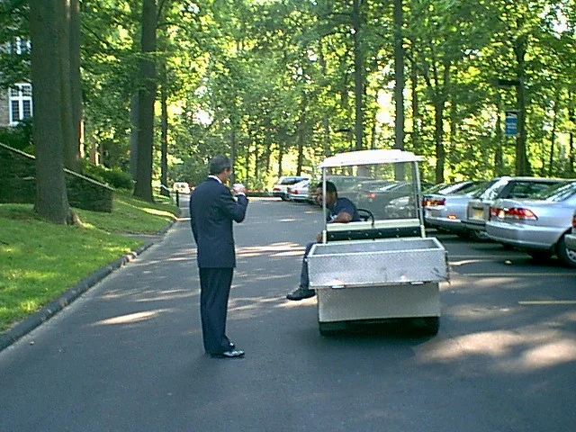 Dr. Bob McCaig stops a maintenece worker on his way to help physically challenged guests. 