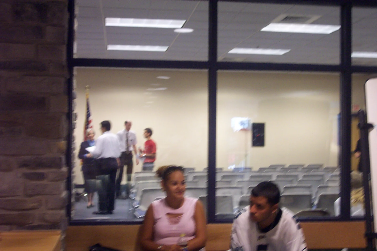 Two students wait outside the room as the ceremony is about to begin. 