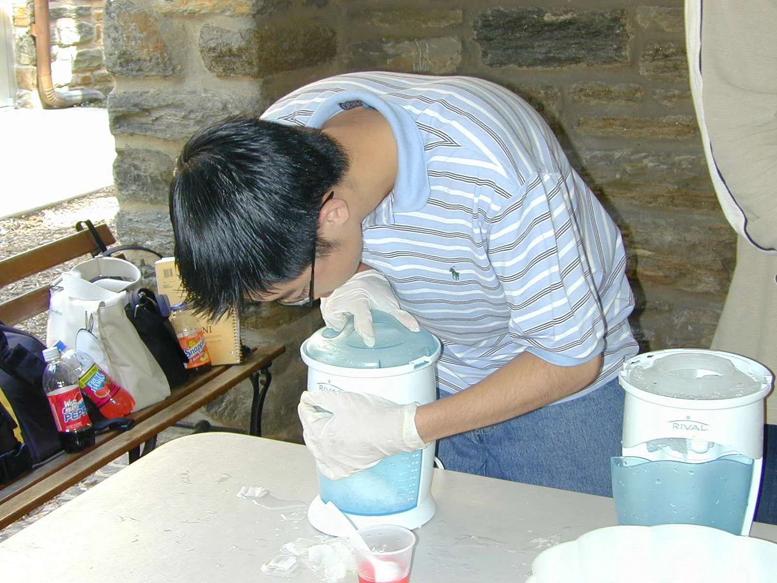 This man mixed the ice for the cones.