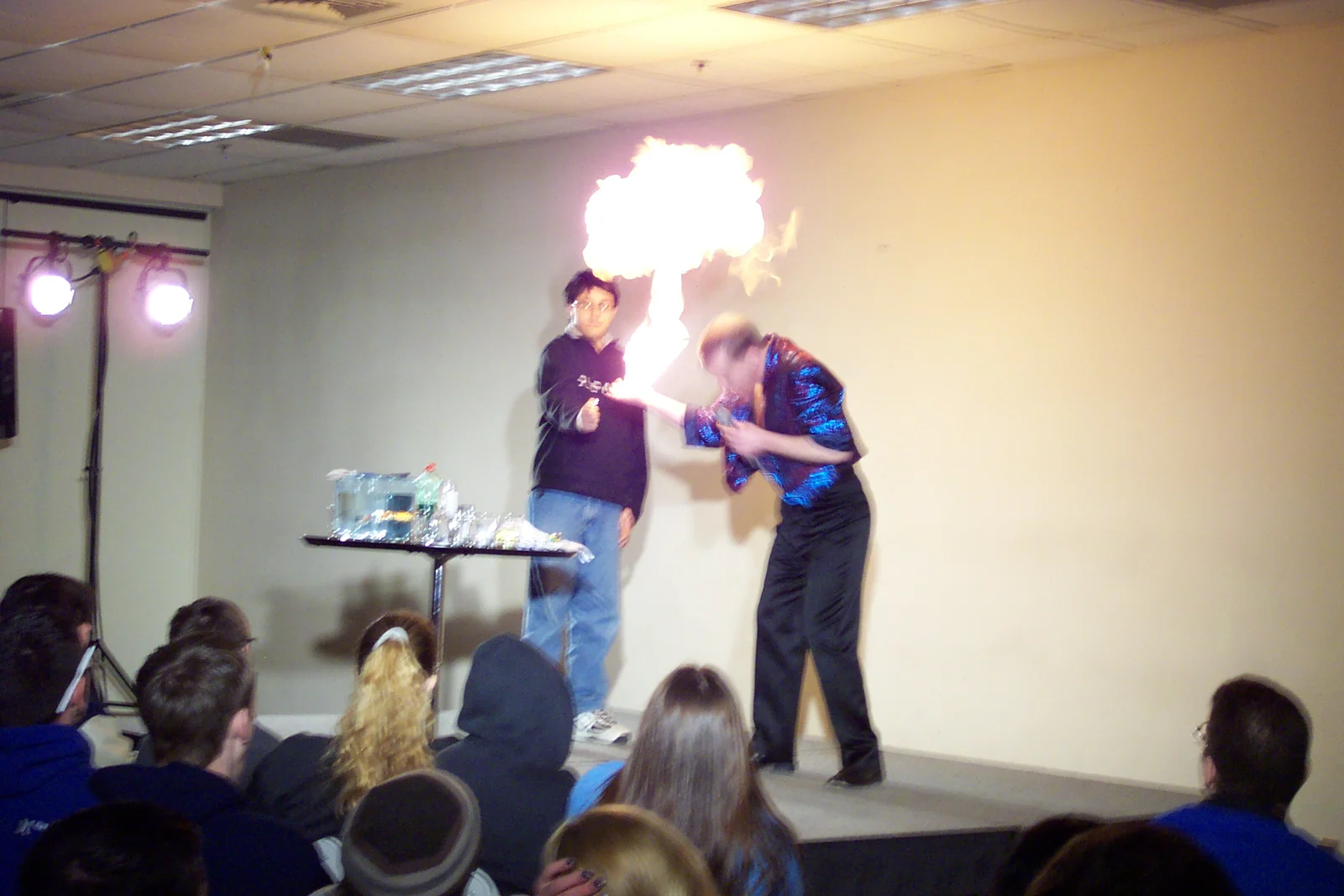 Here, Stevie regurgitates lighter fluid while an assistant holds a match.