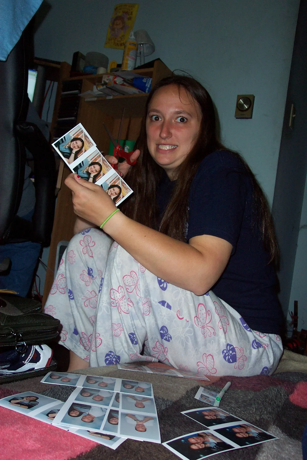 Sarah looks like she's about to kill somebody as she holds up pictures of herself to the camera. 