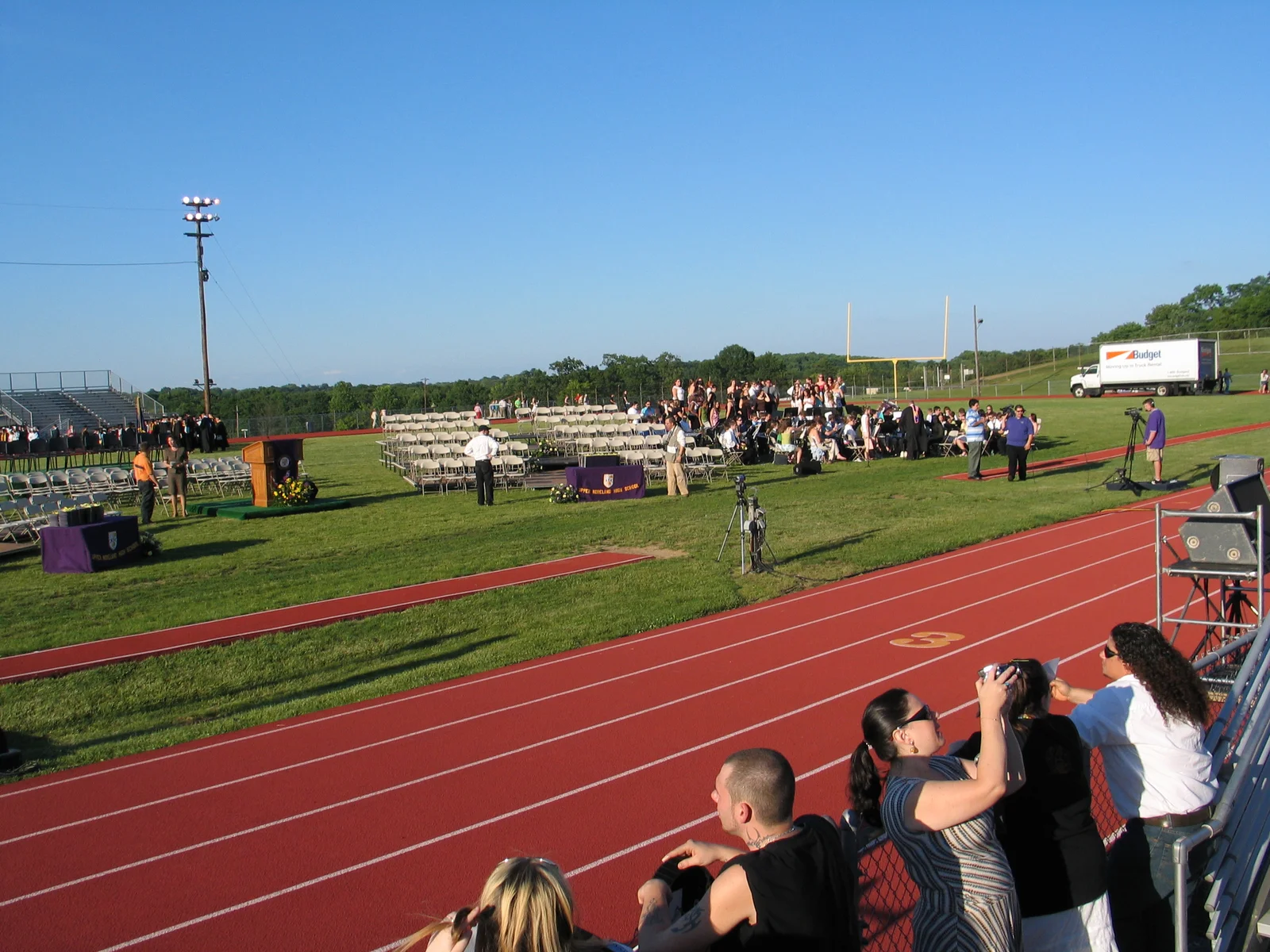The track at the high school was empty and so were the graduates' chairs, as everyone waited for people to arrive. 