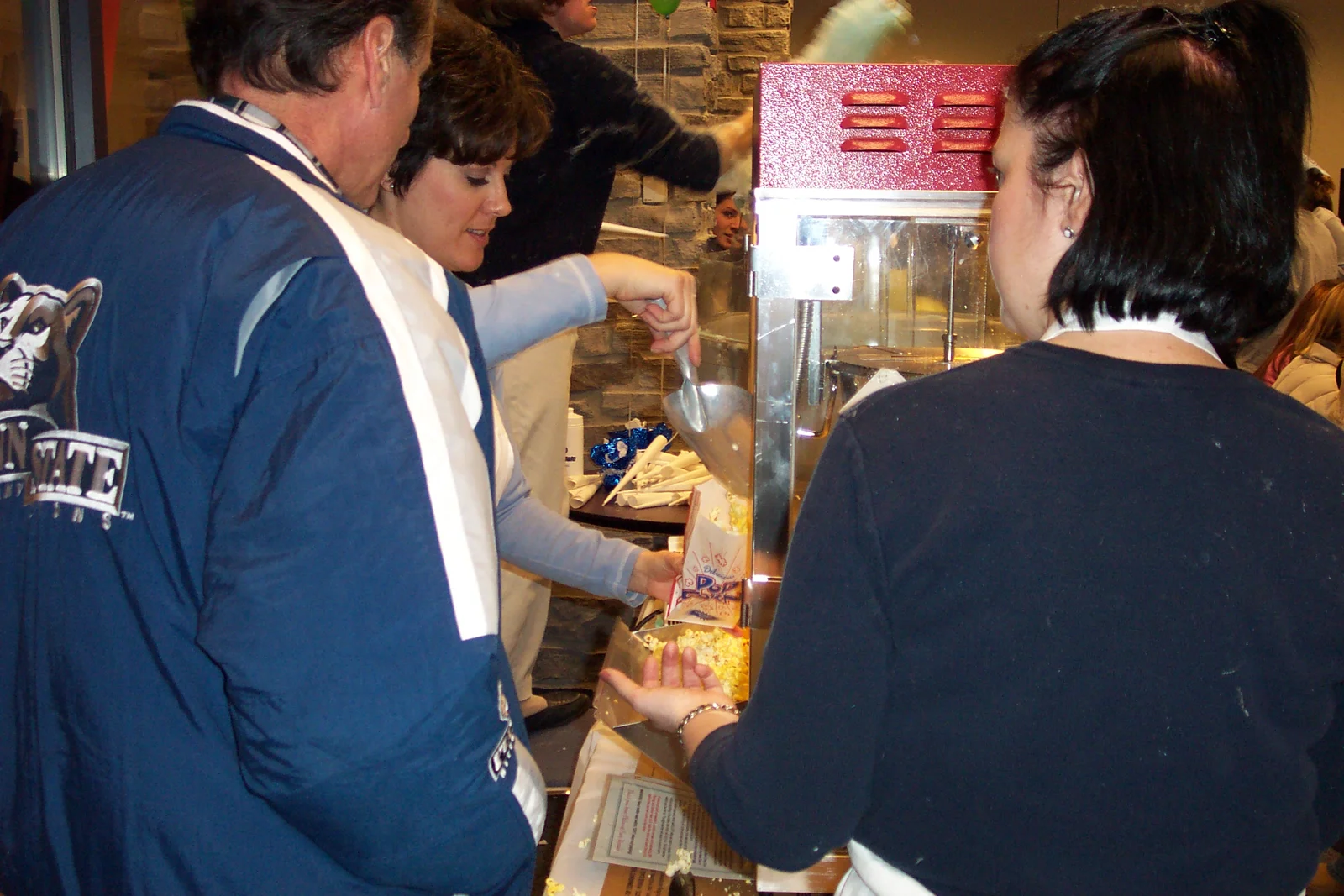 Bob Barton and Tracy McClintic chat at the popcorn booth.
