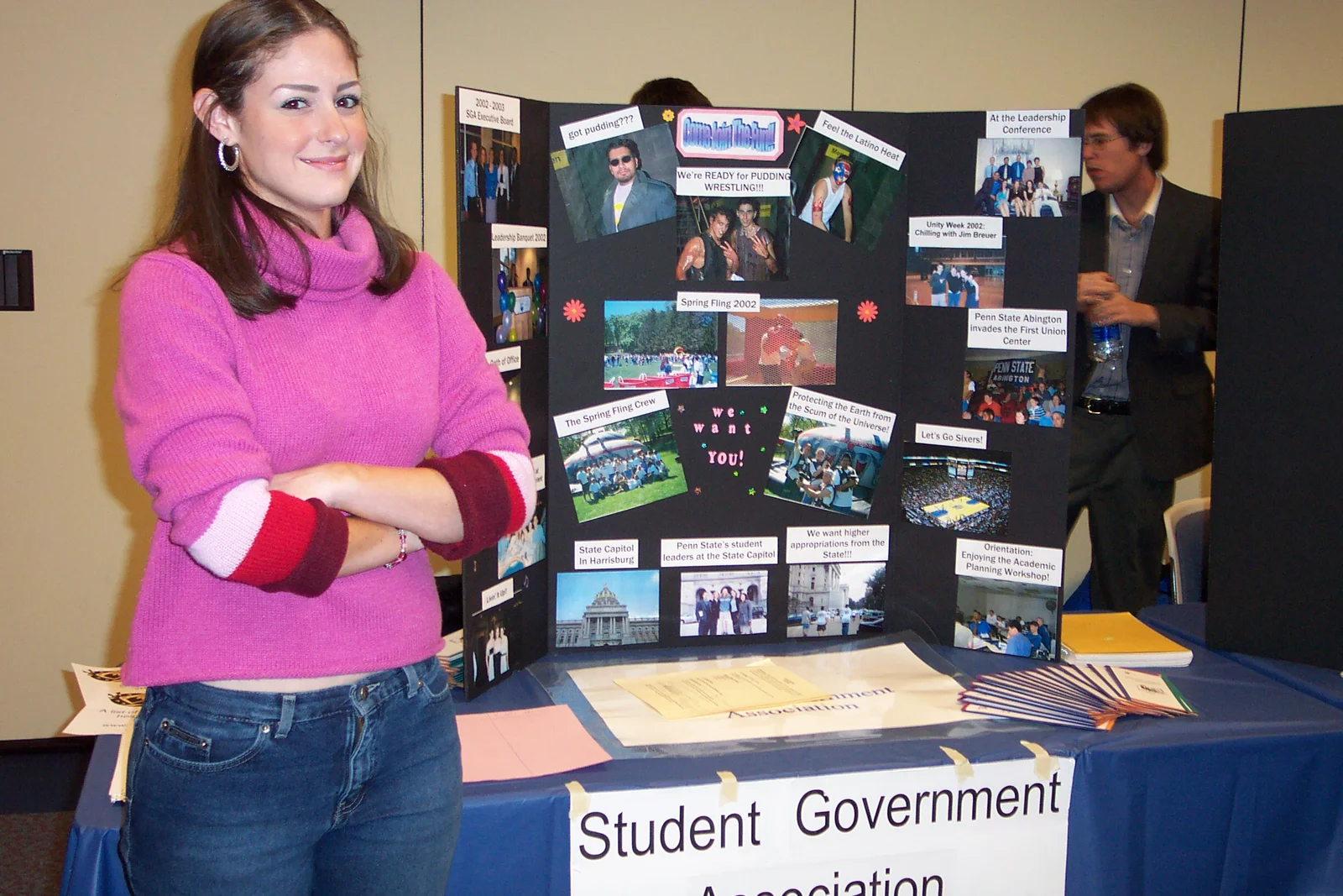 Treasurer Ashley Martin represents the Student Government Association with a poster she created to her right.