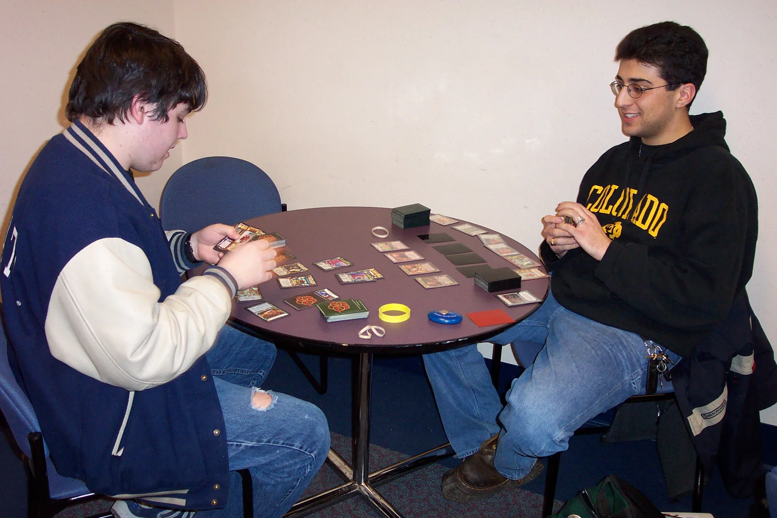 John Silvestri and Adam play a card game in the student lounge.