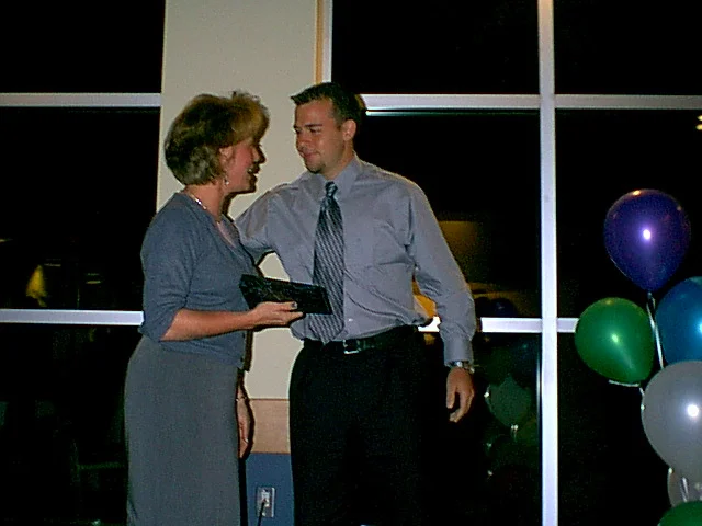Public Relations Officer Chris Brown congratulates Marcia Delia on her award.