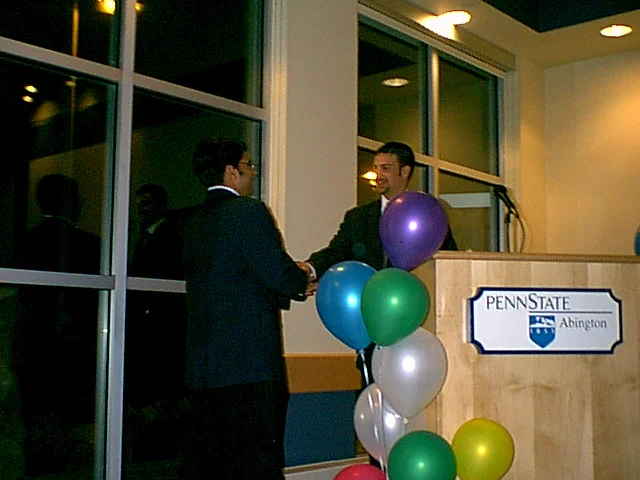 SGA President Ninad Pendharkar and former President Drew Lavenberg shake hands. 