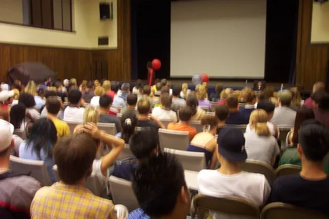 The crowd bounced rubber balls around while waiting for Patrick Combs to start speaking. 