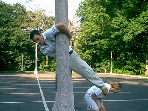 Kristina can't contain her laughter as Soroosh twists himself around a light pole. 