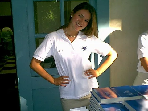Lisa Zubak sparkles in the sunlight behind the bluebooks on the registration table. 