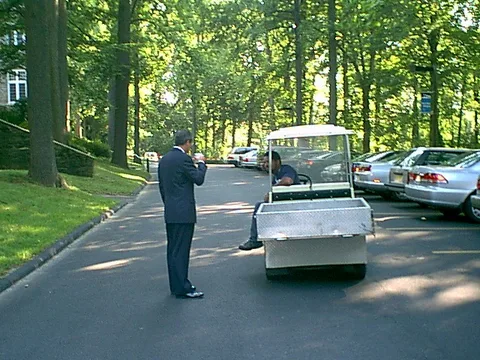 Dr. Bob McCaig stops a maintenece worker on his way to help physically challenged guests. 