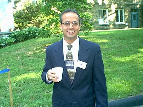Dr. Bob smiles for the camera, coffee in hand. 