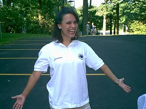 Jeneane stretches her arms in the parking lot as the students arrive. 