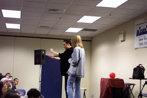 A woman is invited onto the stage.
