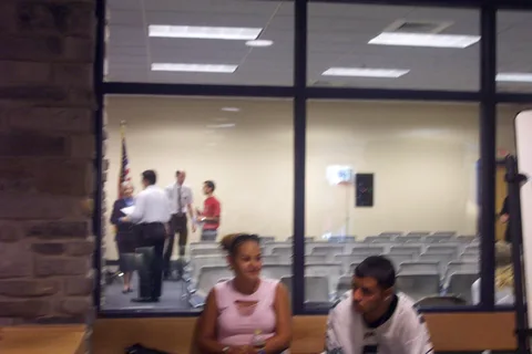 Two students wait outside the room as the ceremony is about to begin.