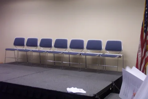 Empty chairs await the dignitaries.