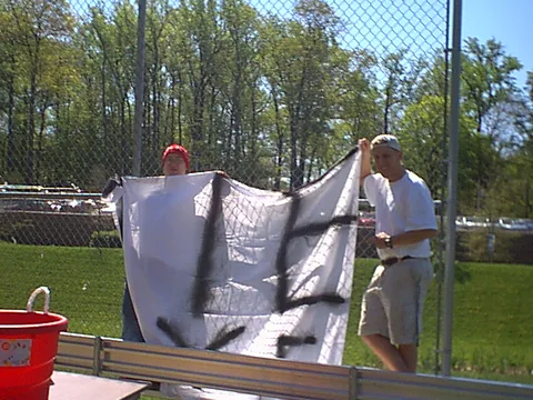 Dane Zdunowski and Ken hang the "Tie Dye" sheet, painted the day before by Jason Bozzone.