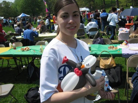 This woman proudly shows off her long-awaited balloon animal.