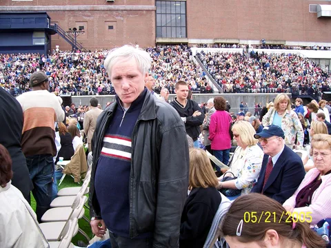 The patriarch of the family cuts through the crowd to his seat. 