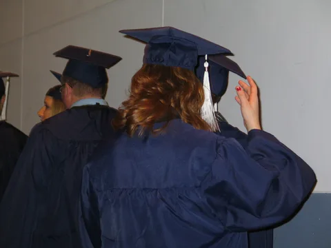 One graduate was spotted adjusting her cap multiple times during the ceremony.  The caps were uncomfortable and cheap. 