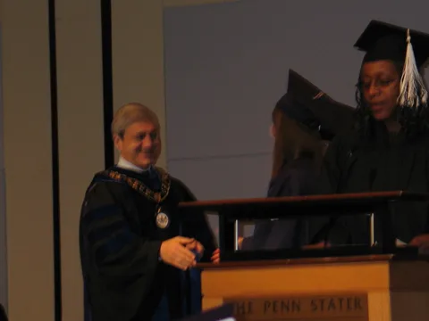 Dr. Spanier looks on as a high-ranking official in the honors college begans calling the names. 
