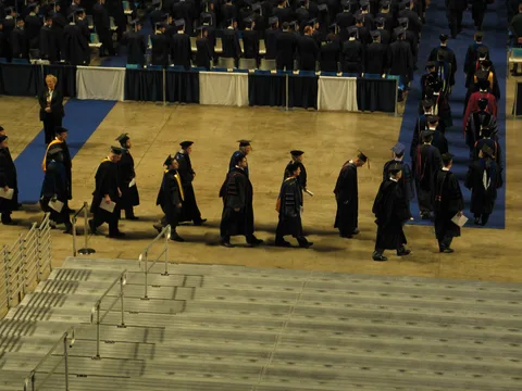 The faculty processed into the arena at their leisure. 