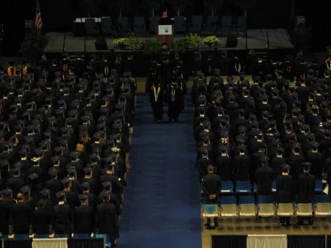 The wooden pole held by the first faculty member in the procession was salvaged from the first Old Main and has been used in the 331 previous commencement ceremonies. 