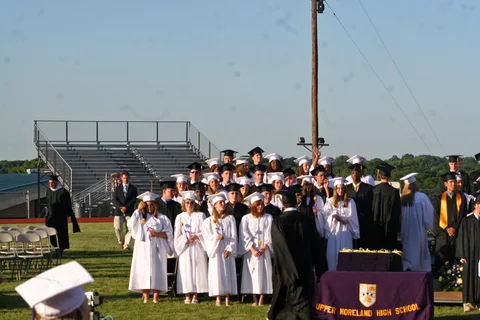 The first order of business was to have a chorus member perform the national anthem, while the graduates stood at attention.