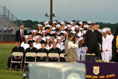 As Michael Casey looks on from the left, students filed down to finish their educations.
