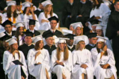 Students here prepare to move the tassels, toss their caps into the air, and bolt off the field in celebration.
