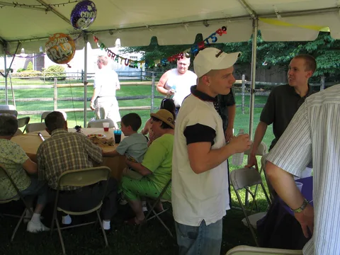 Tony Hoffman, Steve Sokolowski, and others discuss the World Cup as they watched it on a portable television.