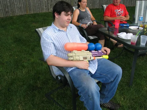 John Silvestri used a 10-year-old Super Soaker to make sure the little kids didn't approach the table.