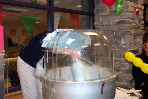 Marcia Delia serves up cotton candy to a long line of visitors. 