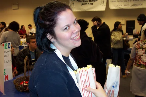 Tracy McClintic walks around delivering popcorn to students. 
