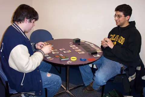 John Silvestri and Adam play a card game in the student lounge. 