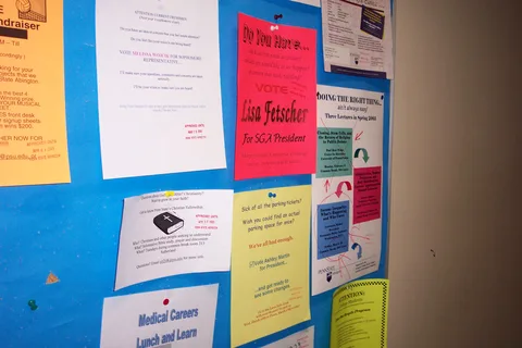 A bulletin board in the Sutherland building where signs are posted.