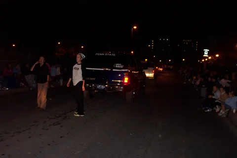 As the parade went on, some dancers became tired and had to rest by walking behind the car. 