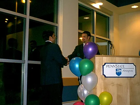 SGA President Ninad Pendharkar and former President Drew Lavenberg shake hands.