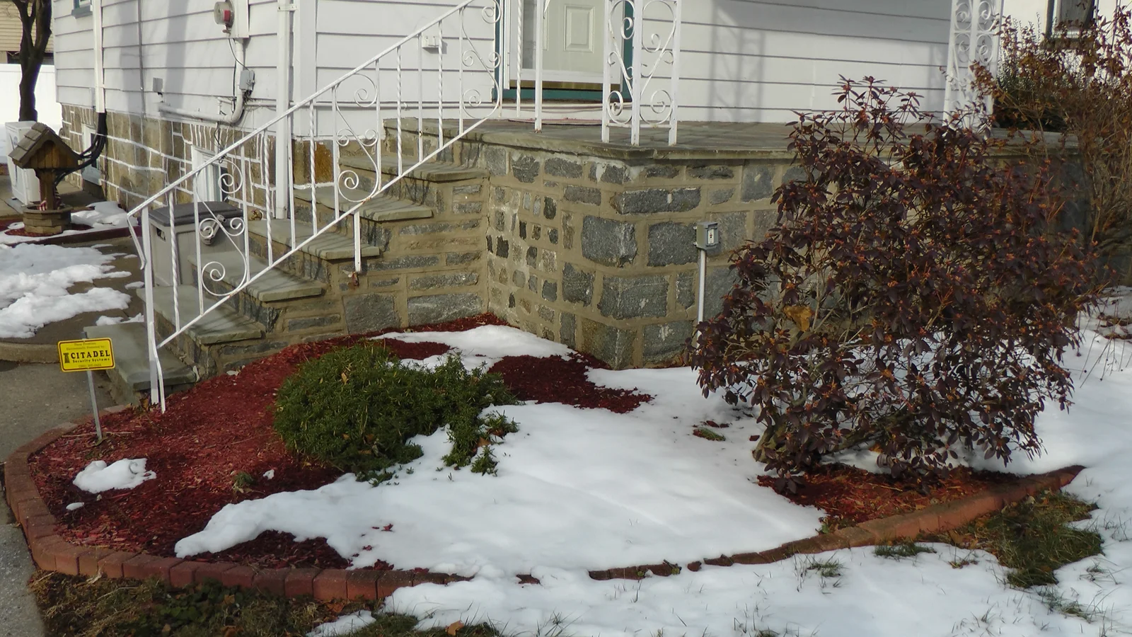 Another view of the porch and beautiful red mulch landscaping.