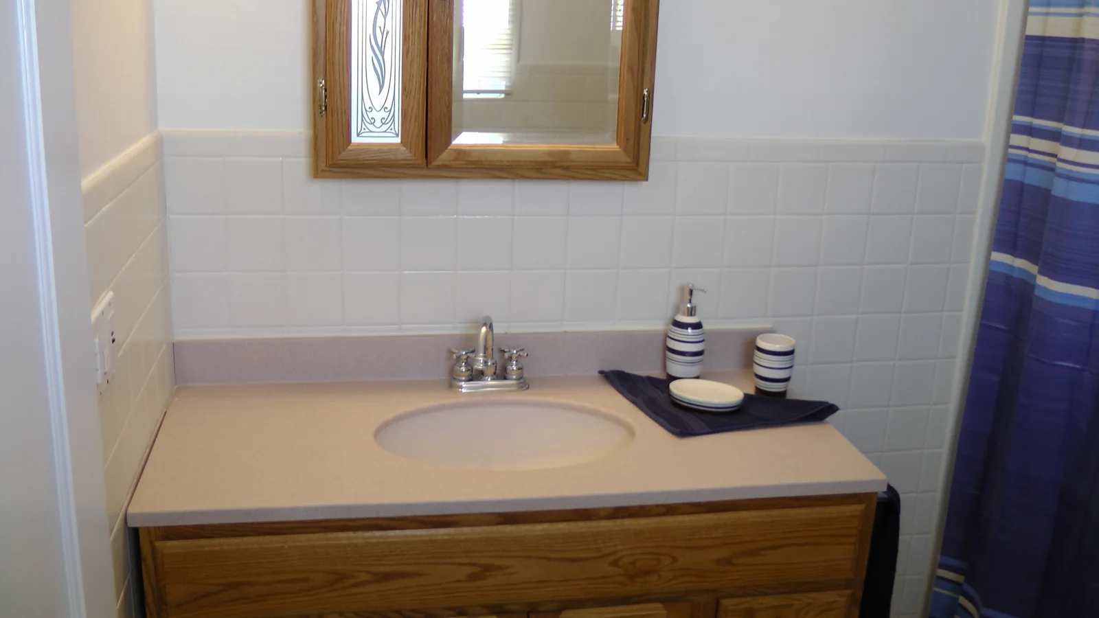 The modern sink and cabinet in the main bathroom.
