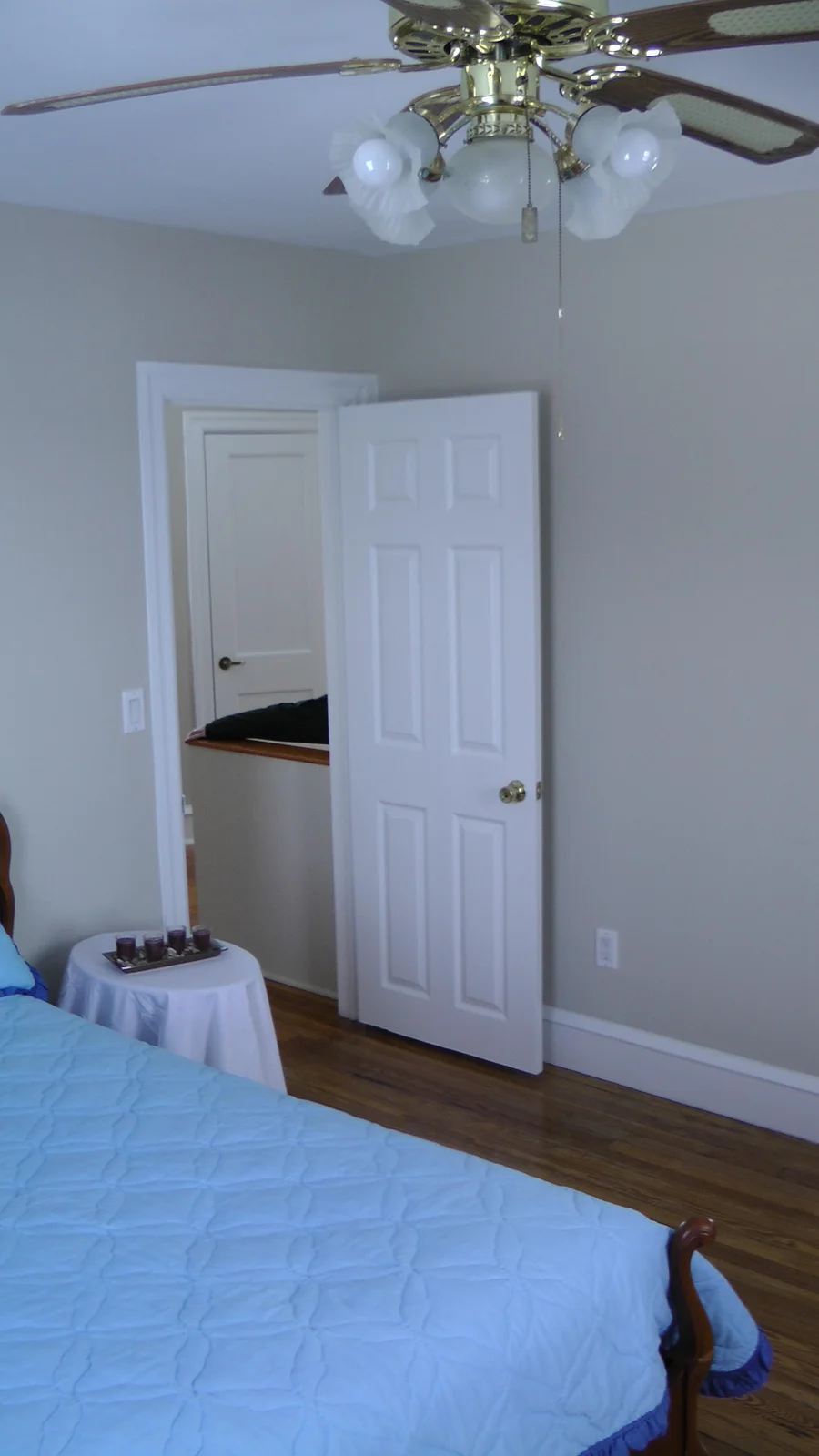 A reverse shot of the master bedroom, showing the ceiling fan and the ample room available to its occupants.