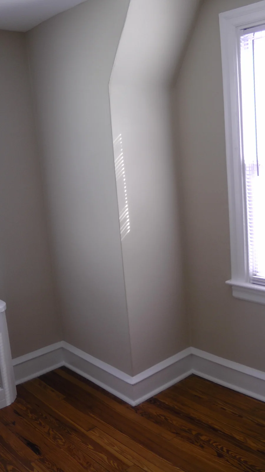 The fresh paint and bright ambient light is visible in this shot of the third bedroom, from a different angle.
