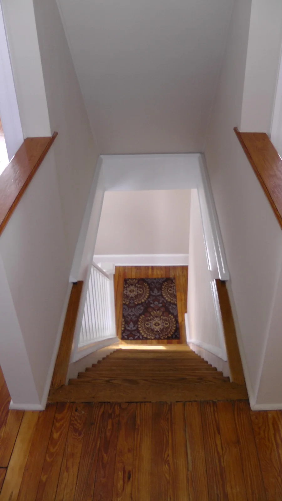 A view down the stairwell from the second floor.  The living room is to the left.