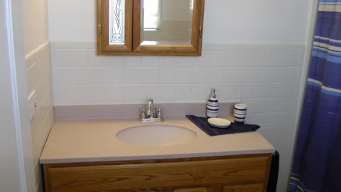 The modern sink and cabinet in the main bathroom.