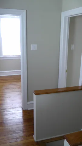 The hallway in the second floor, facing the other two bedrooms.