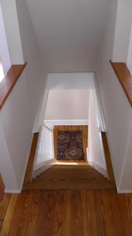 A view down the stairwell from the second floor.  The living room is to the left.
