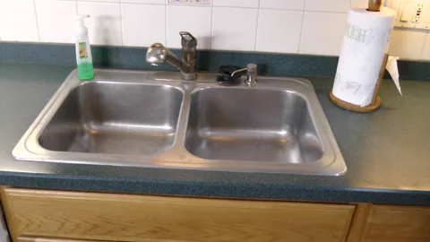 The kitchen sink includes a pullout spray tool for washing pots and pans, and contains two parts for maximum flexibility.